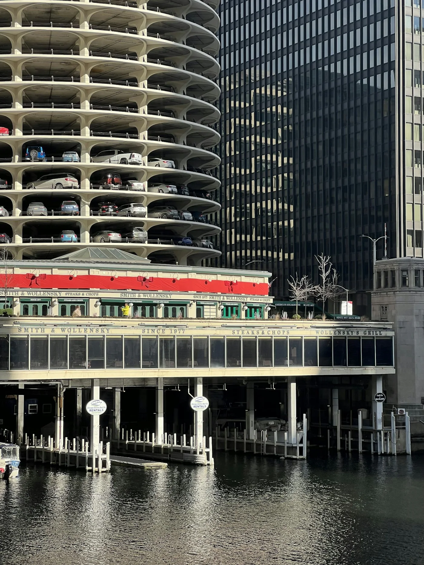 Marina City balconies above a red and white boat on the river