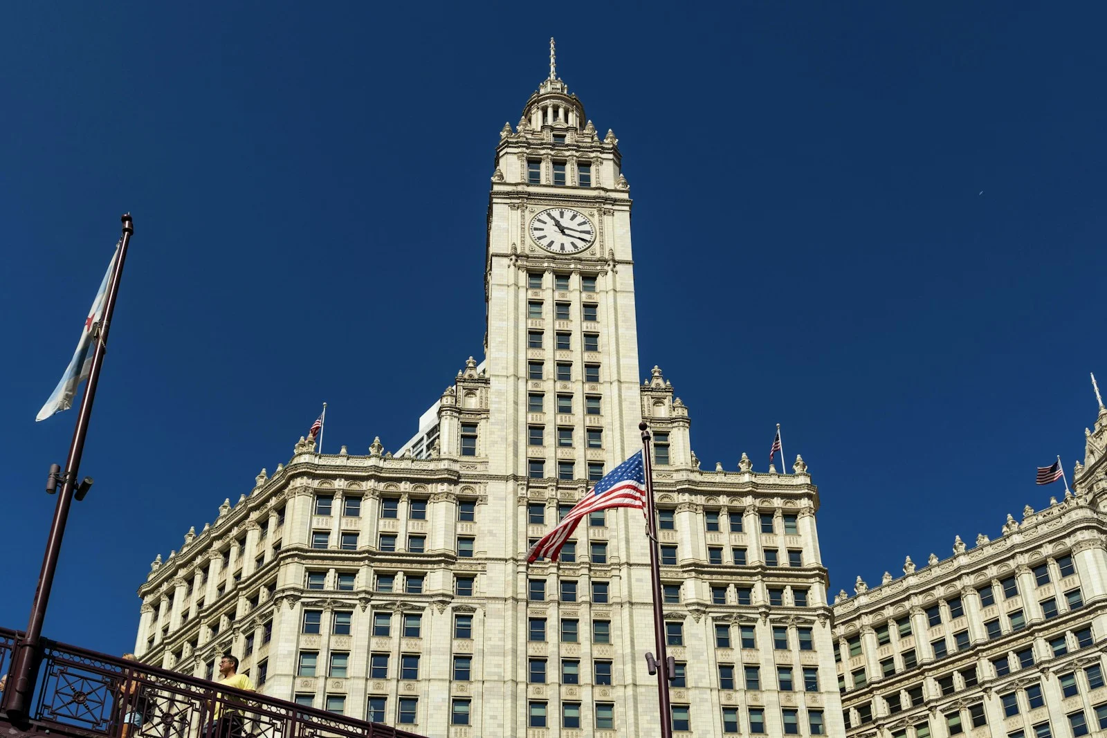 The Wrigley Building clock tower and facade against a blue sky