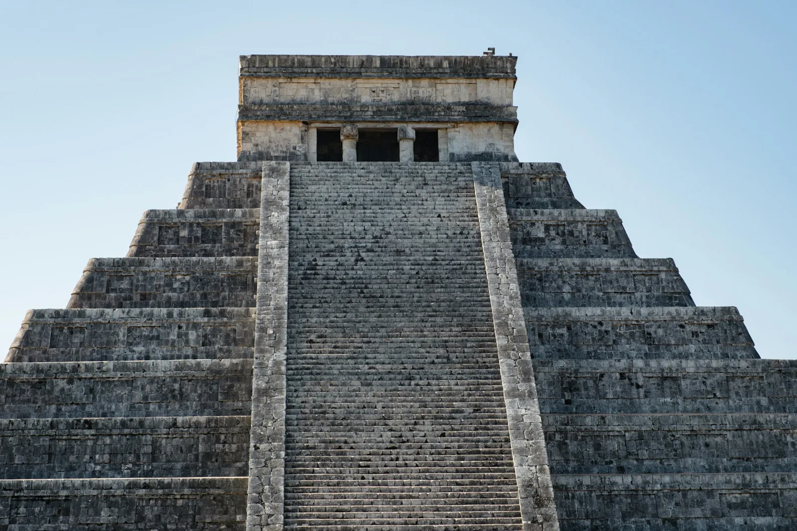 El Castillo pyramid at Chichen Itza beneath a blue sky