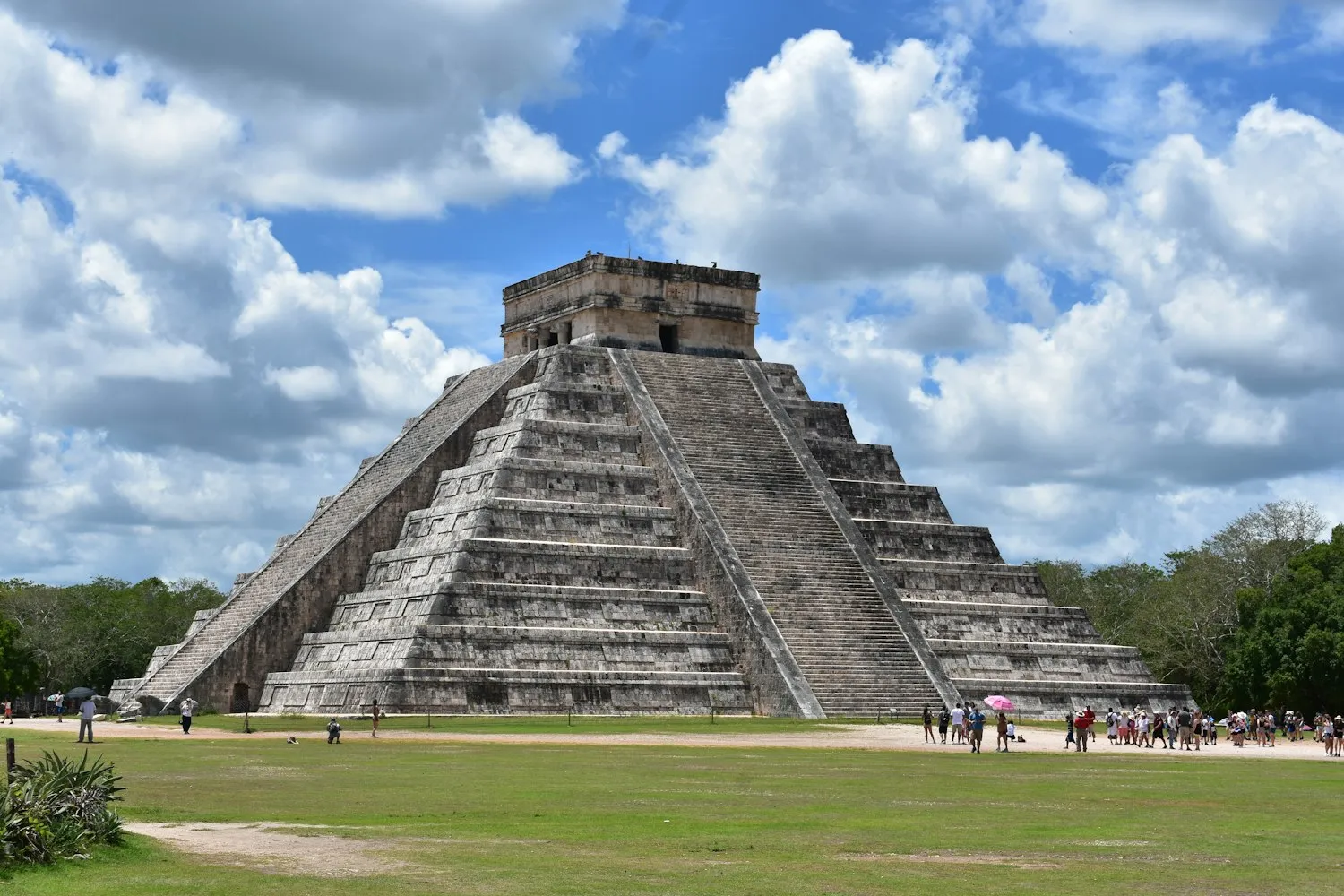 Visitors beside the pyramid at Chichén Itzá