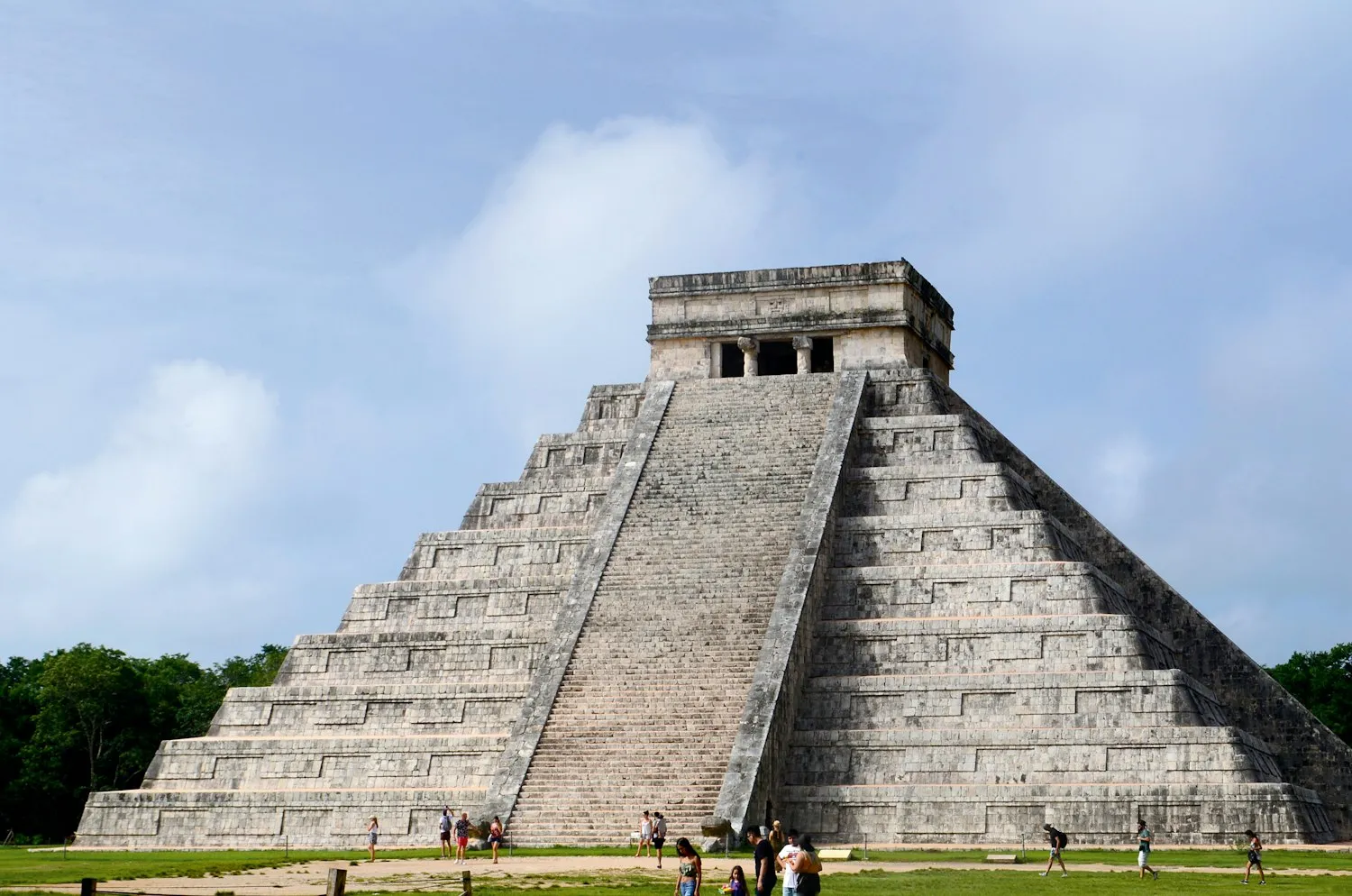 Visitors walking near the pyramid