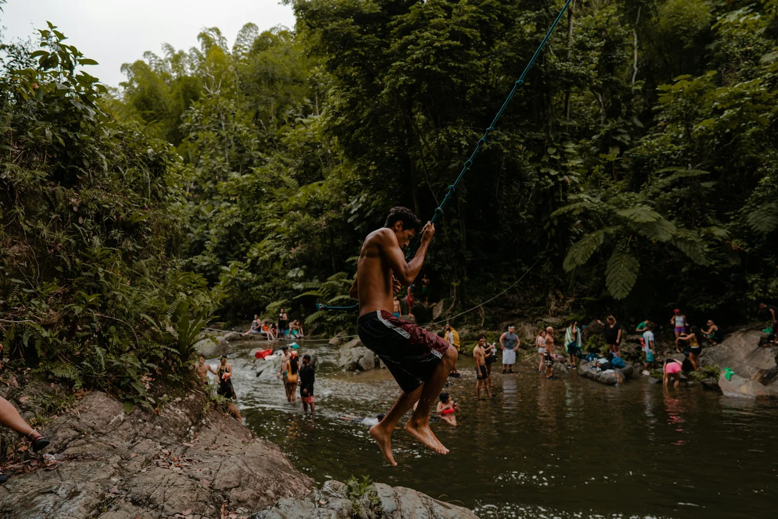 Visitors at a rainforest swimming hole