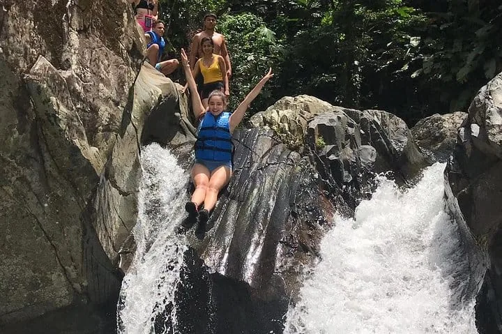 A participant at a natural waterslide on the Spotin rainforest outing