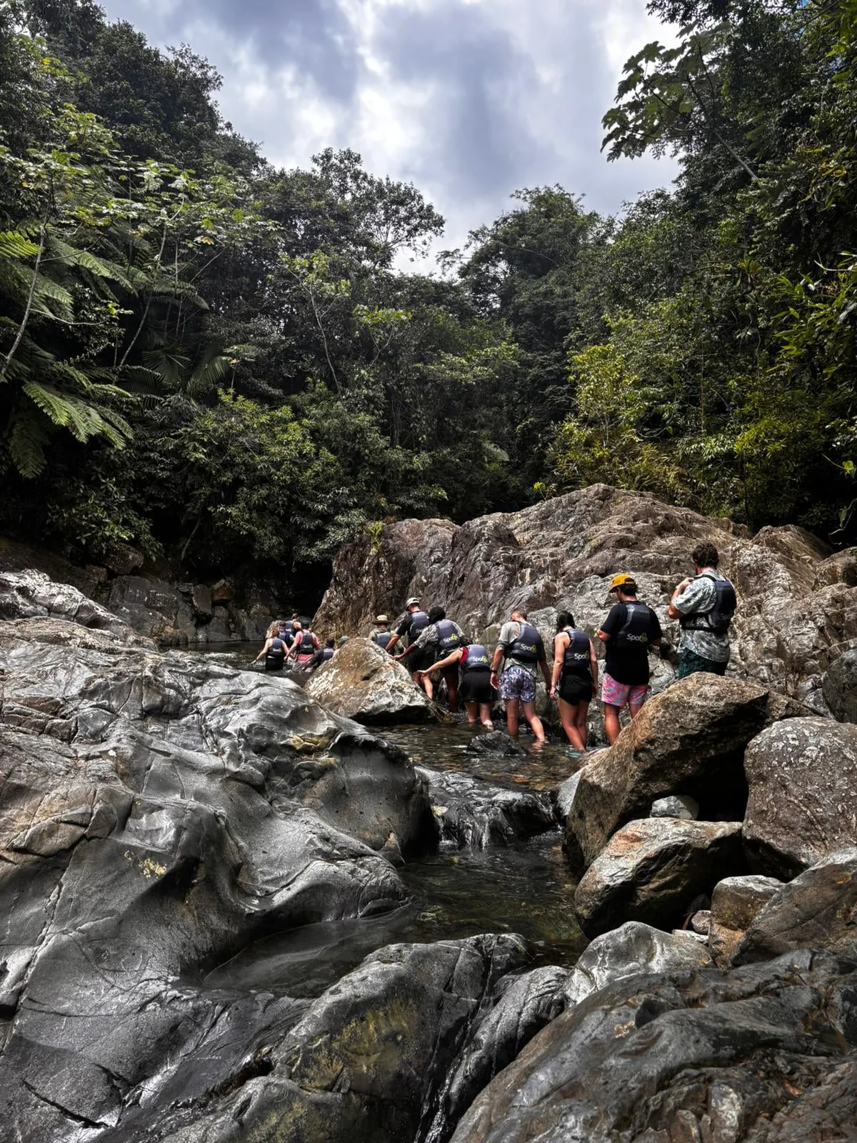 Travelers negotiating the rocky river section with Spotin guides