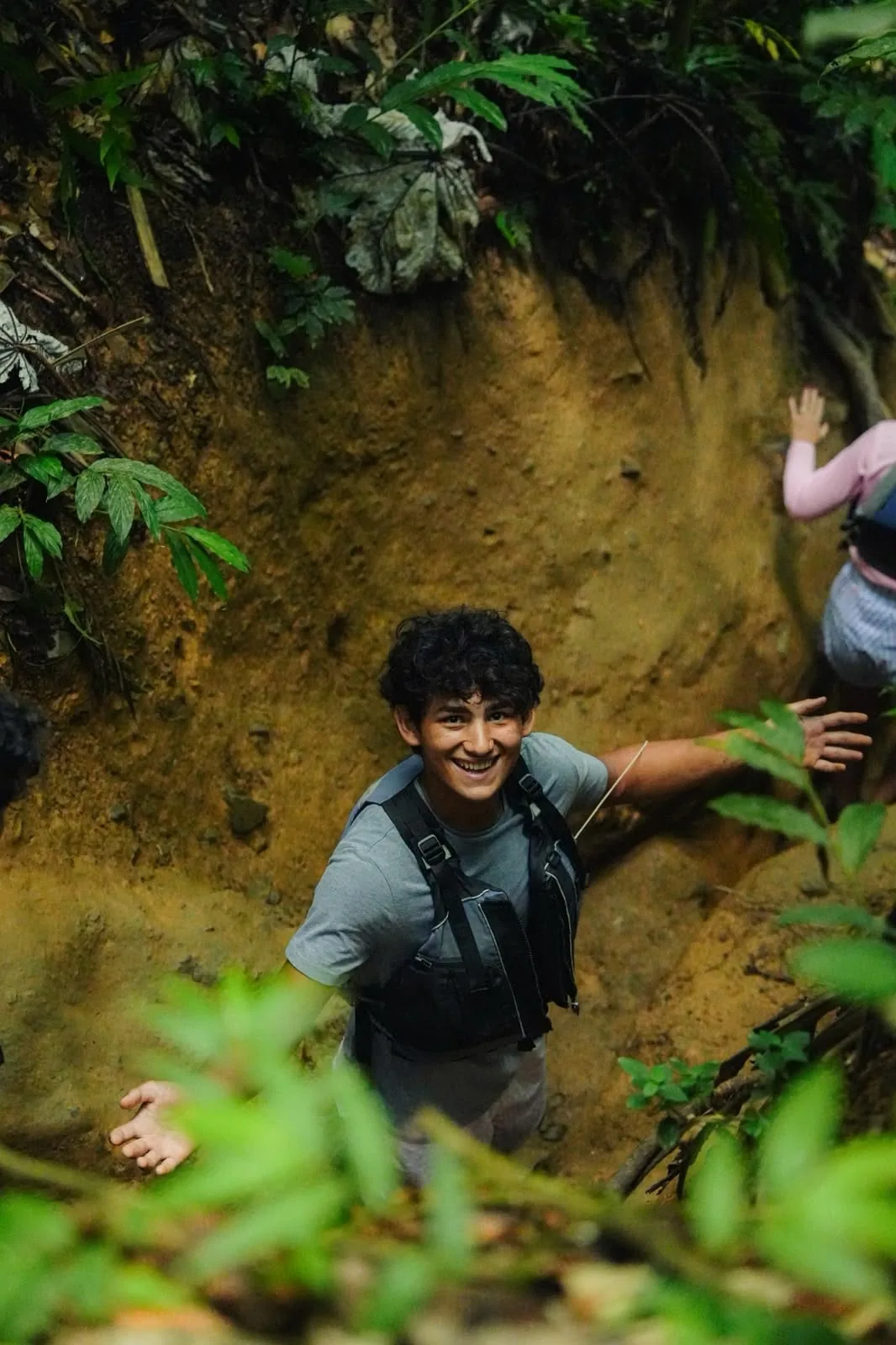 A traveler on a narrow muddy forest path