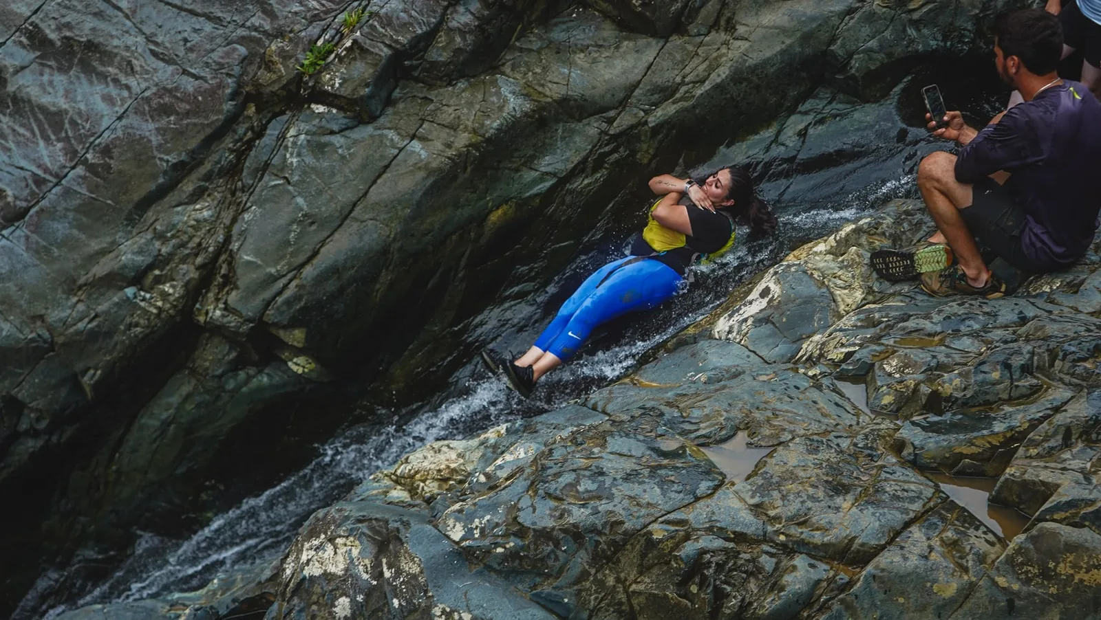 A participant on a natural waterslide in the rainforest