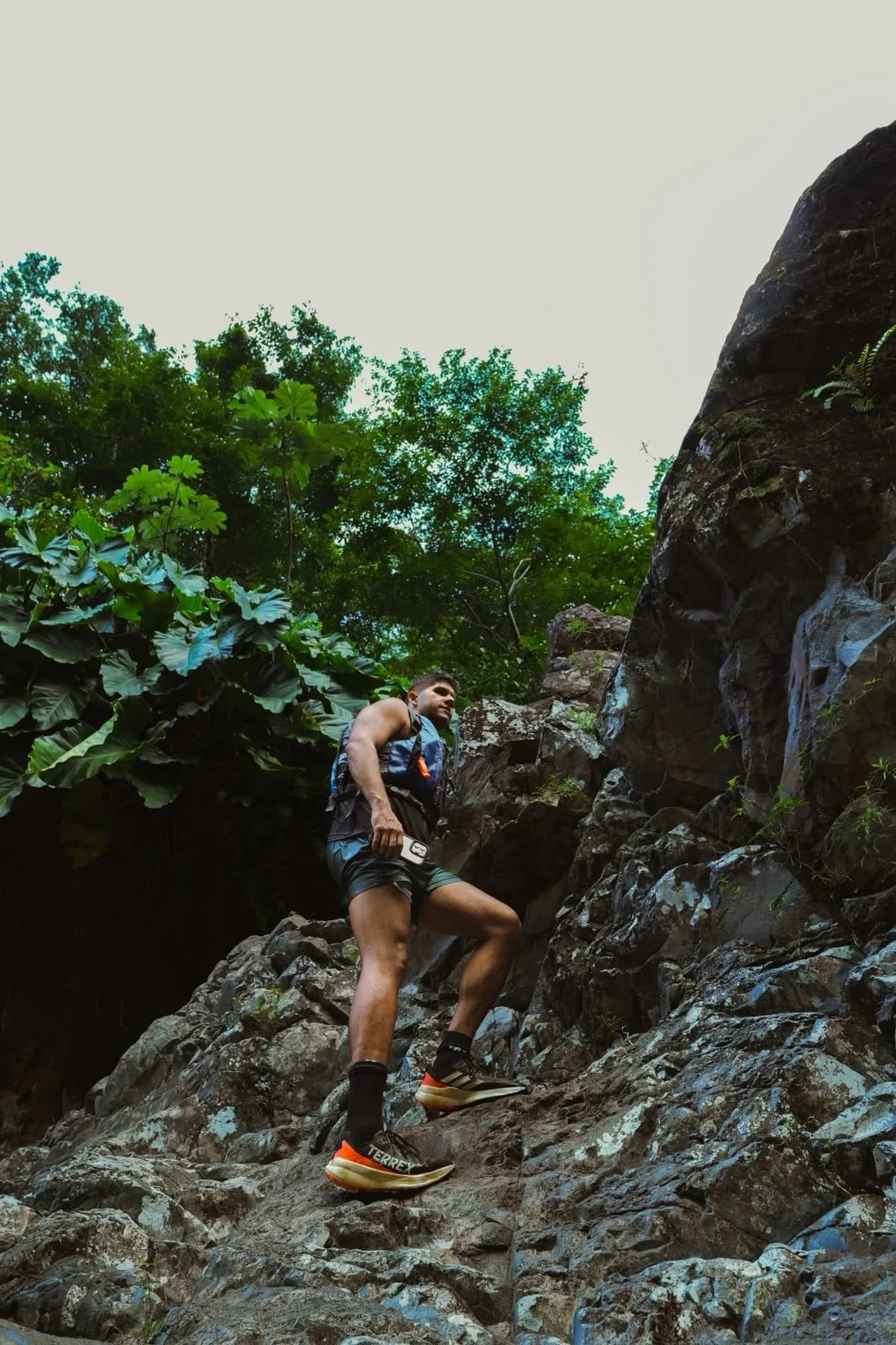 A traveler stepping between rocks beside the river