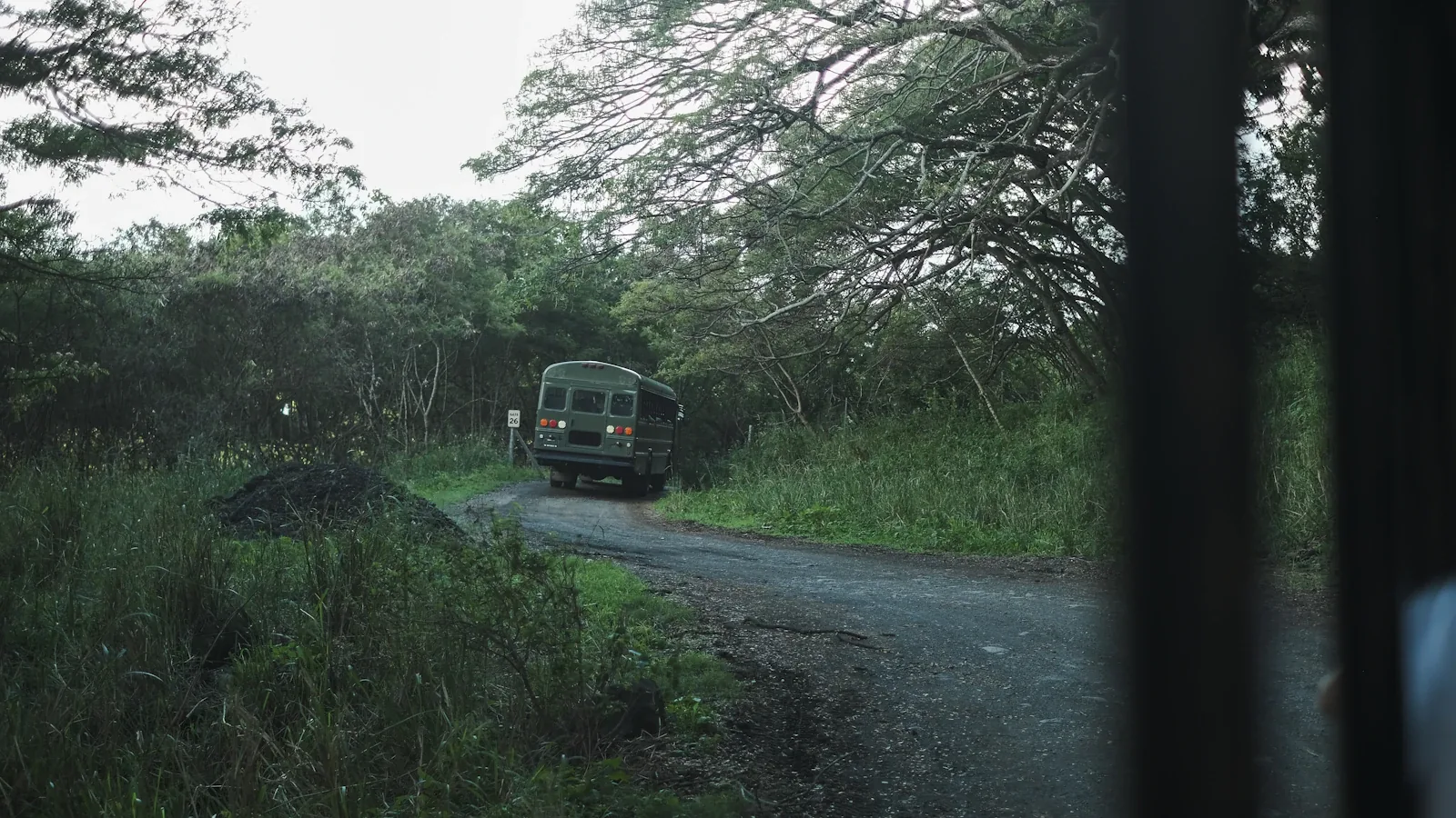 An open-air tour truck on a ranch road