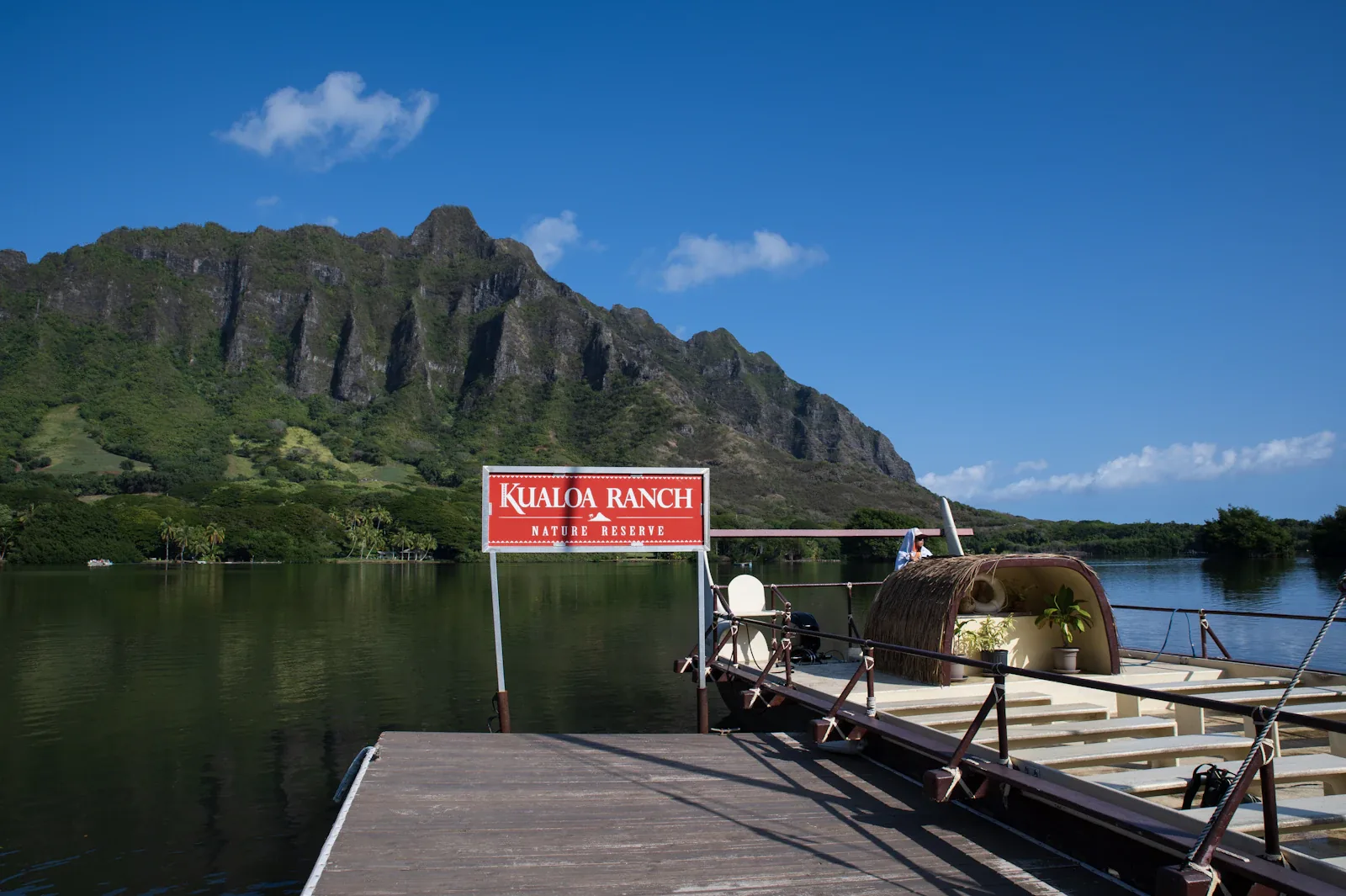 A Kualoa Ranch sign by the water