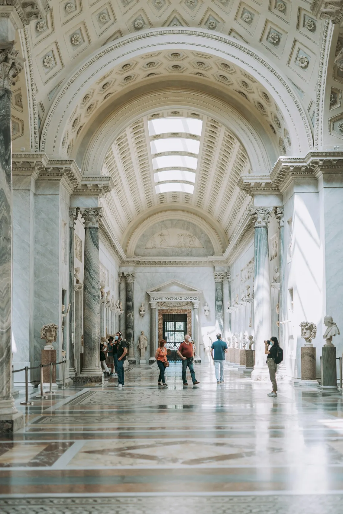 Visitors walking through a museum gallery