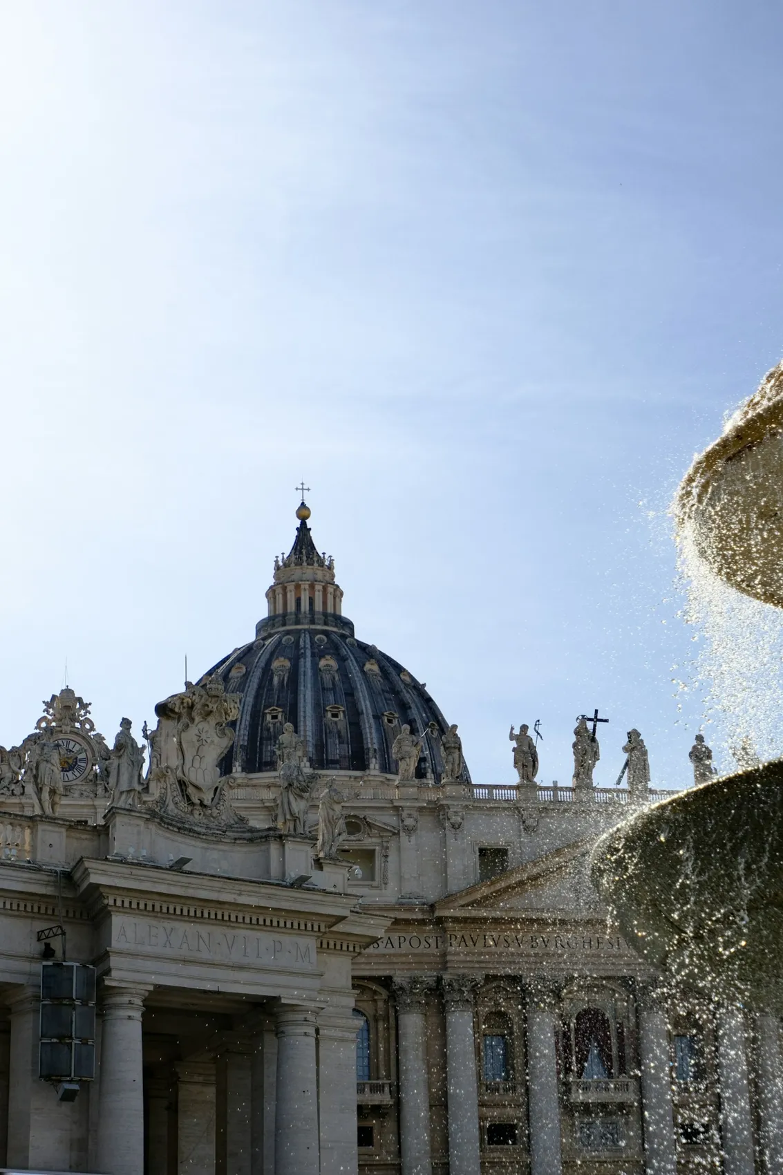 A fountain and the dome in St. Peter’s Square